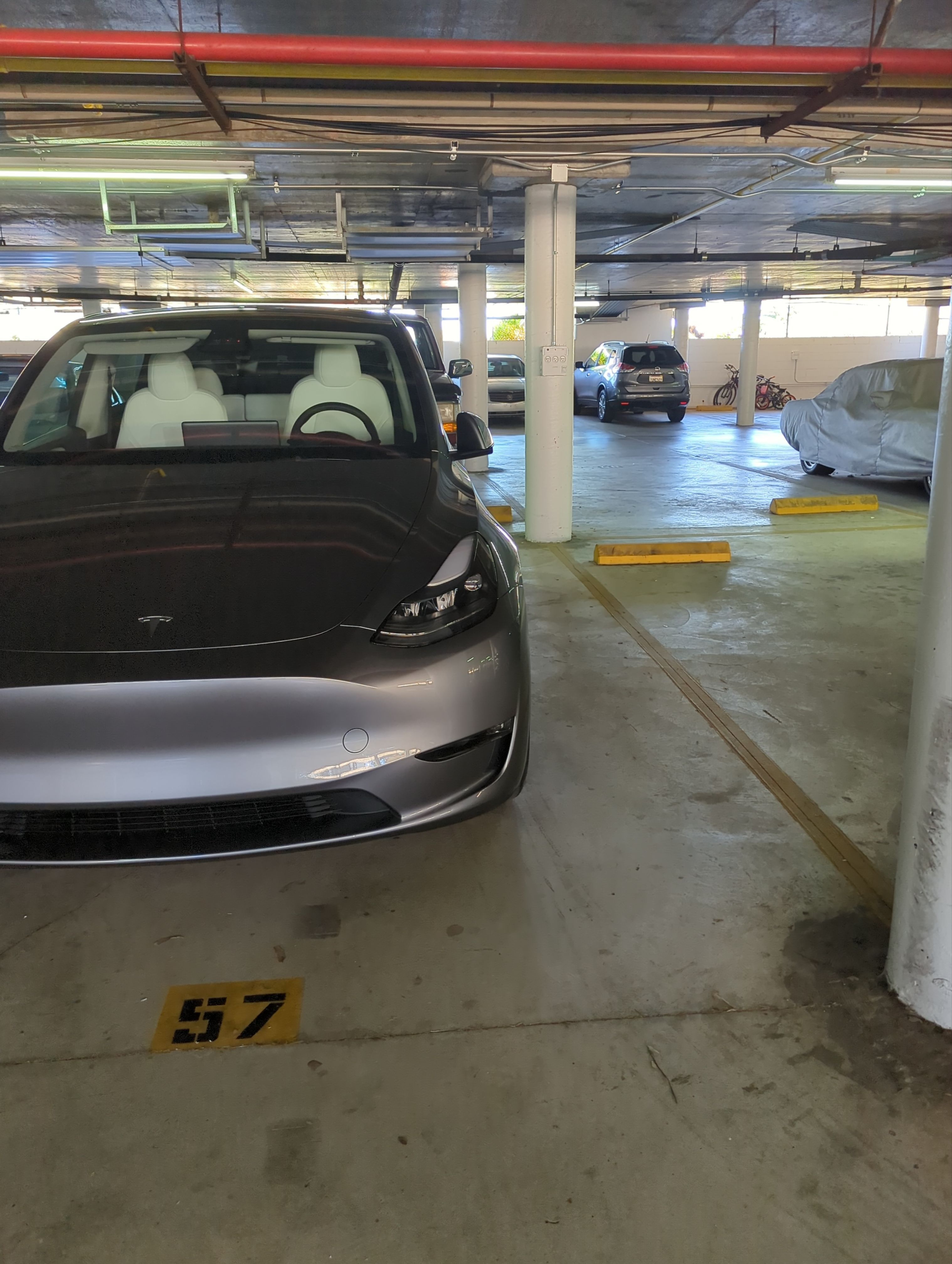 EVs charging across a multifamily parking structure